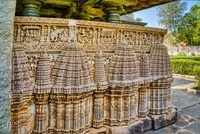 Carvings on the parapet wall - sequences from Mahabharata- Khandava forest burning, Below the parapet wall Beautifully carved miniature temple towers 