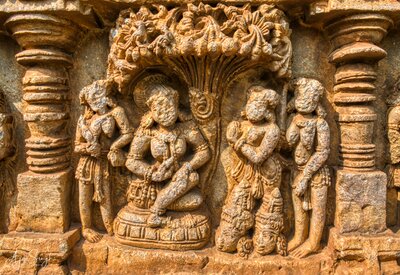 Ravana fakes the death of Rama and Lakshmana to Seeta. See the two heads on the ground., Carving on the parapet wall - sequences from the epic Ramayana
