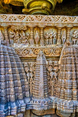 Below the parapet wall Beautifully carved miniatures of temple tower-like structures, Carving on the parapet wall - sequences from the epic Ramayana - Rama wins against Ravana and reunites with Seeta.